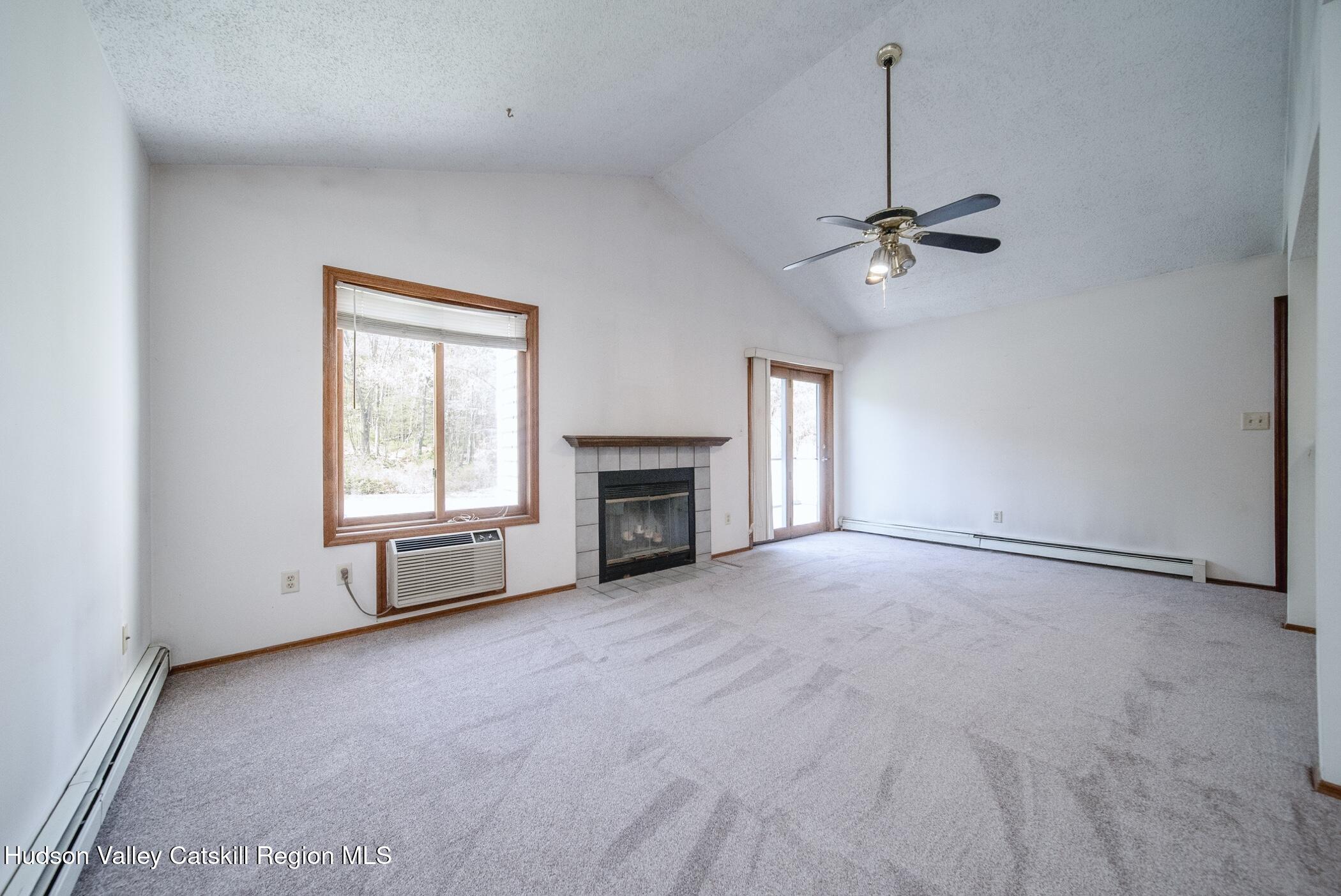 9 Rock Maple Road Saugerties, NY 12477 - Photo 8 of 30 a view of an empty room with a fireplace and a window