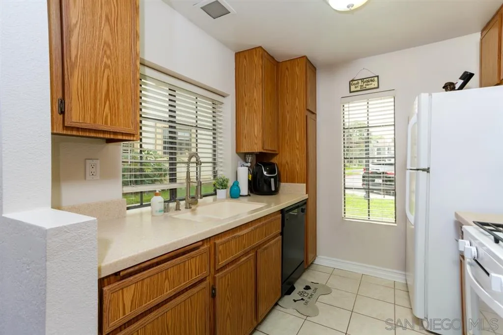 8558 Summerdale Road, Unit 133 San Diego, CA 92126 - Photo 5 of 14 a kitchen with a sink cabinets and a window