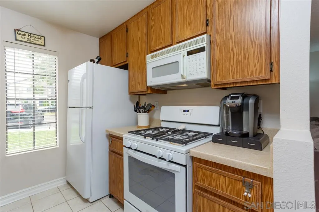 8558 Summerdale Road, Unit 133 San Diego, CA 92126 - Photo 6 of 14 a kitchen with a stove and a microwave