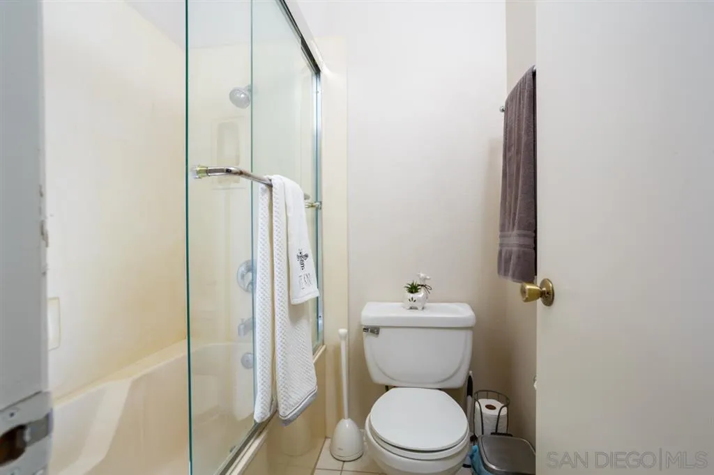 8558 Summerdale Road, Unit 133 San Diego, CA 92126 - Photo 9 of 14 a bathroom with a toilet and a shower