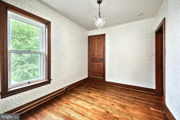 a spacious bedroom with a bed and a chandelier