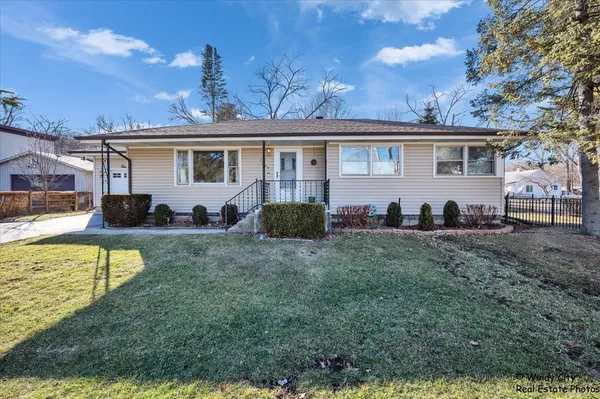 a view of a yard in front of a house with large tree
