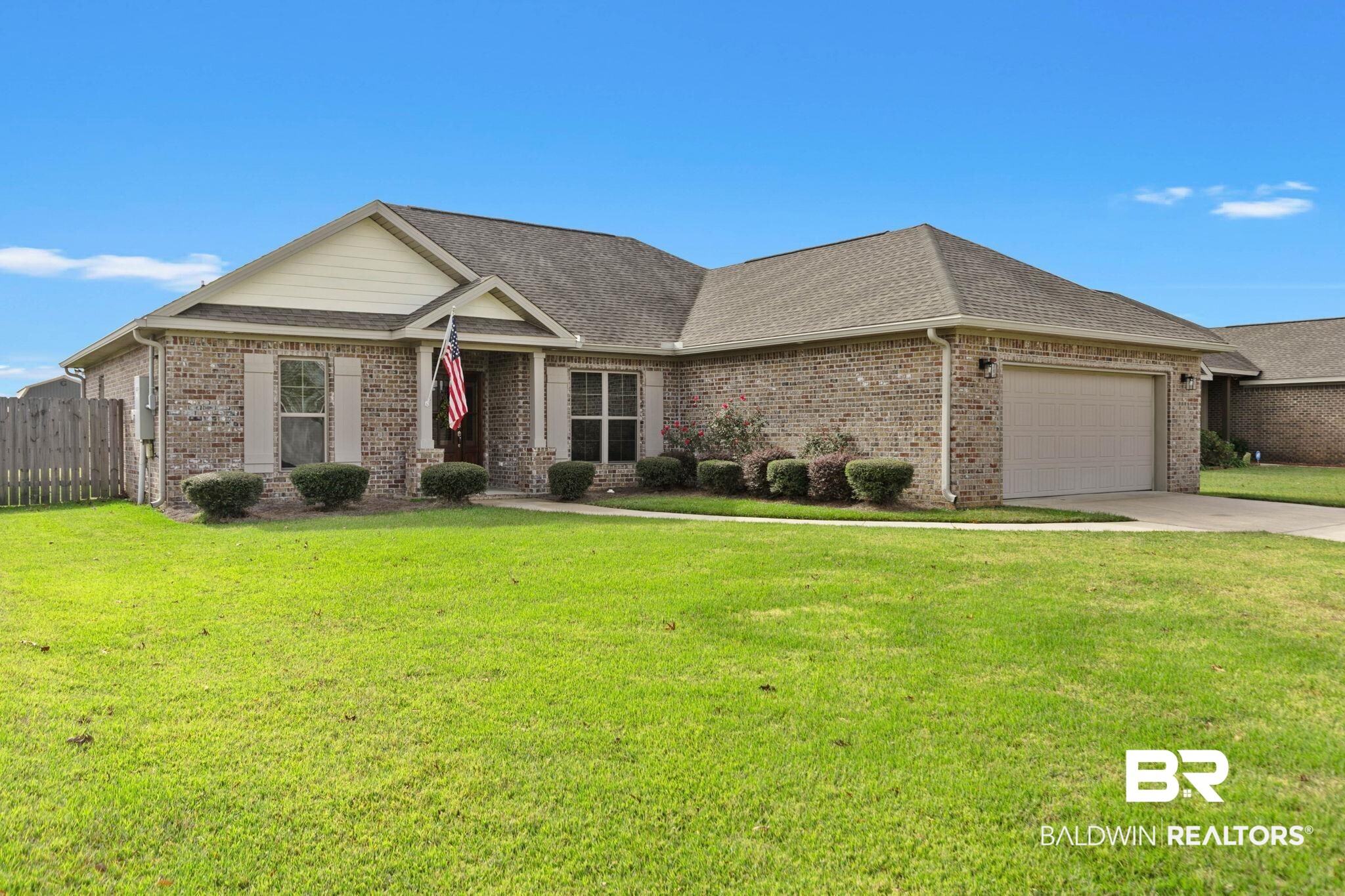 9388 Pembrook Loop Fairhope, AL 36532 - Photo 6 of 53 View of front of home with brick siding, an attached garage, concrete driveway, and roof with shingles