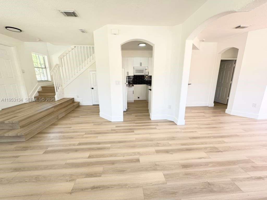a view of empty room and wooden floor