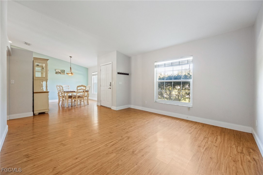 14150 Benedict Street Fort Myers, FL 33905 - Photo 11 of 31 wooden floor in an empty room with a window