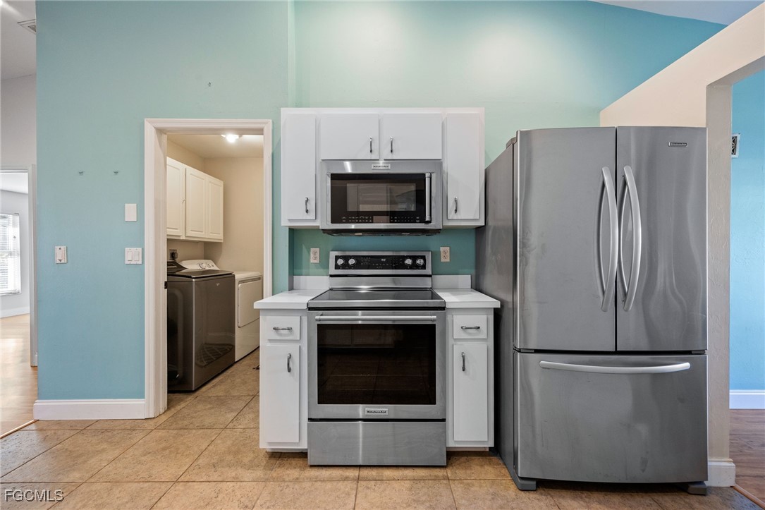 14150 Benedict Street Fort Myers, FL 33905 - Photo 14 of 31 a kitchen with a stove microwave and refrigerator
