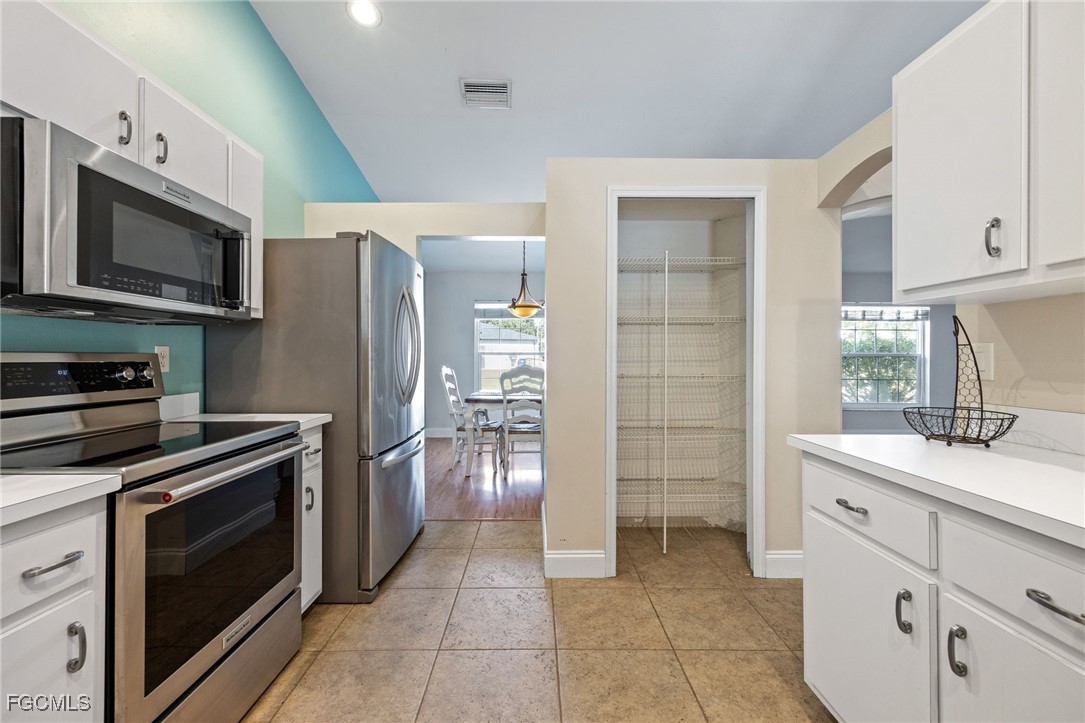 14150 Benedict Street Fort Myers, FL 33905 - Photo 15 of 31 a kitchen with stainless steel appliances a stove sink and refrigerator