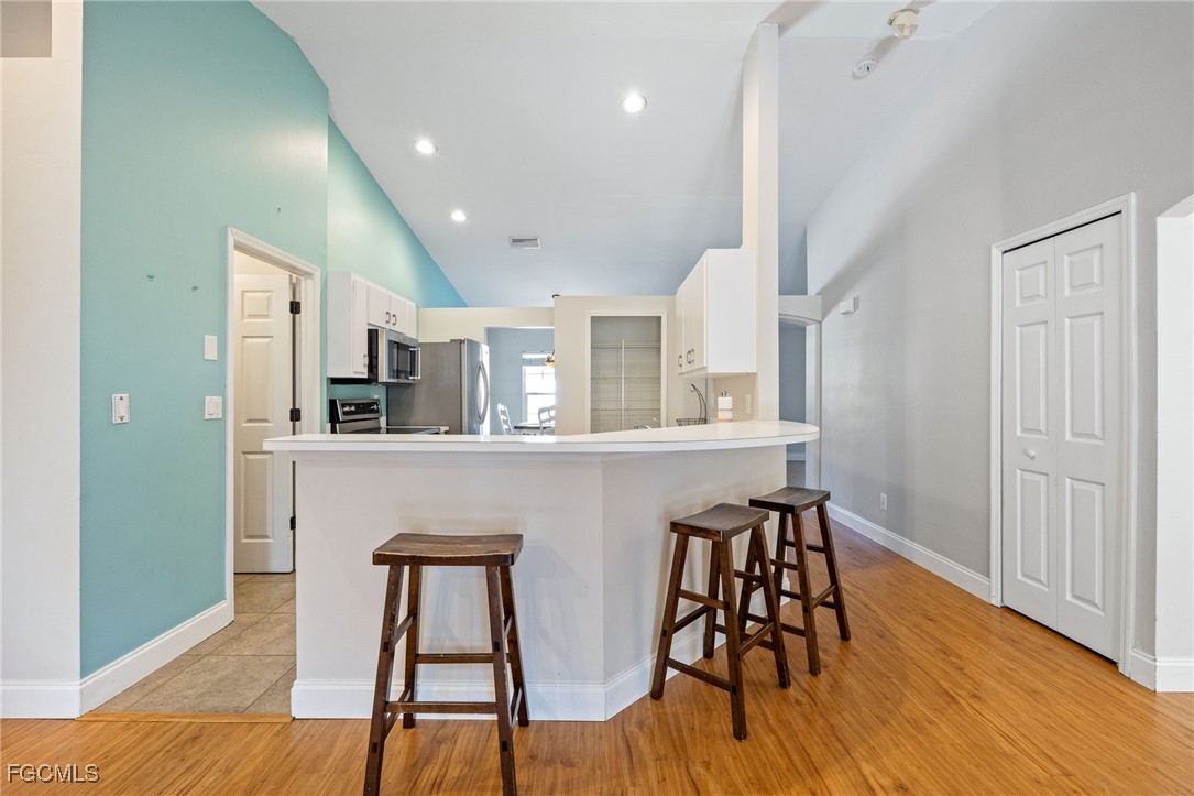 14150 Benedict Street Fort Myers, FL 33905 - Photo 16 of 31 a workspace with wooden floor and windows