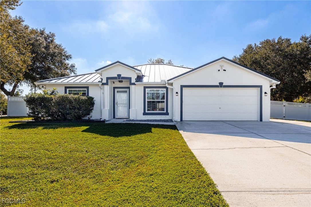 14150 Benedict Street Fort Myers, FL 33905 - Photo 2 of 31 a front view of a house with yard