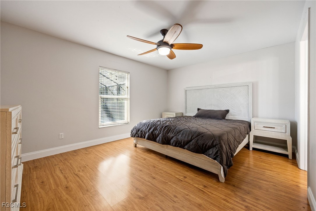 14150 Benedict Street Fort Myers, FL 33905 - Photo 21 of 31 a bedroom with a bed and wooden floor