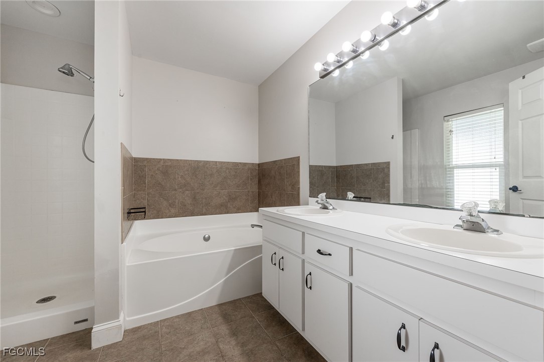 14150 Benedict Street Fort Myers, FL 33905 - Photo 22 of 31 a bathroom with a sink a large mirror and vanity