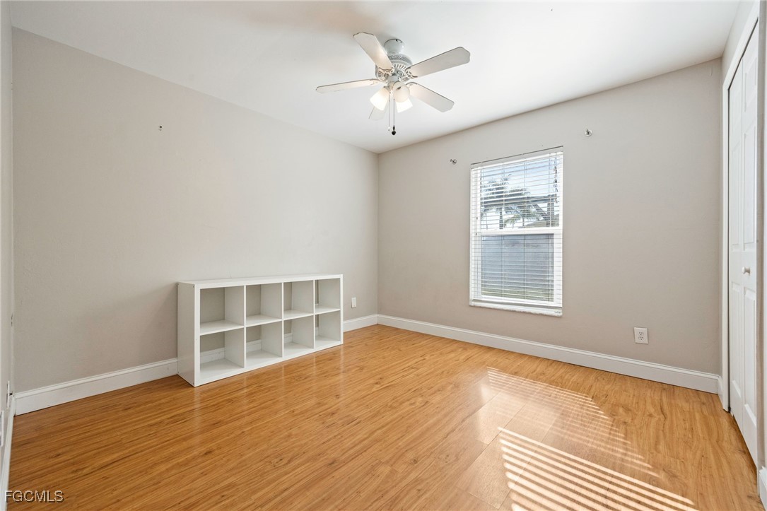 14150 Benedict Street Fort Myers, FL 33905 - Photo 23 of 31 wooden floor in an empty room with a window