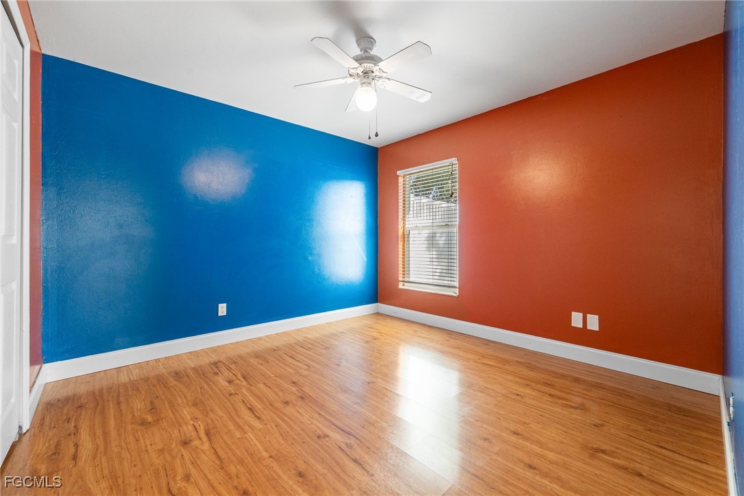 14150 Benedict Street Fort Myers, FL 33905 - Photo 25 of 31 a view of an empty room with window and wooden floor
