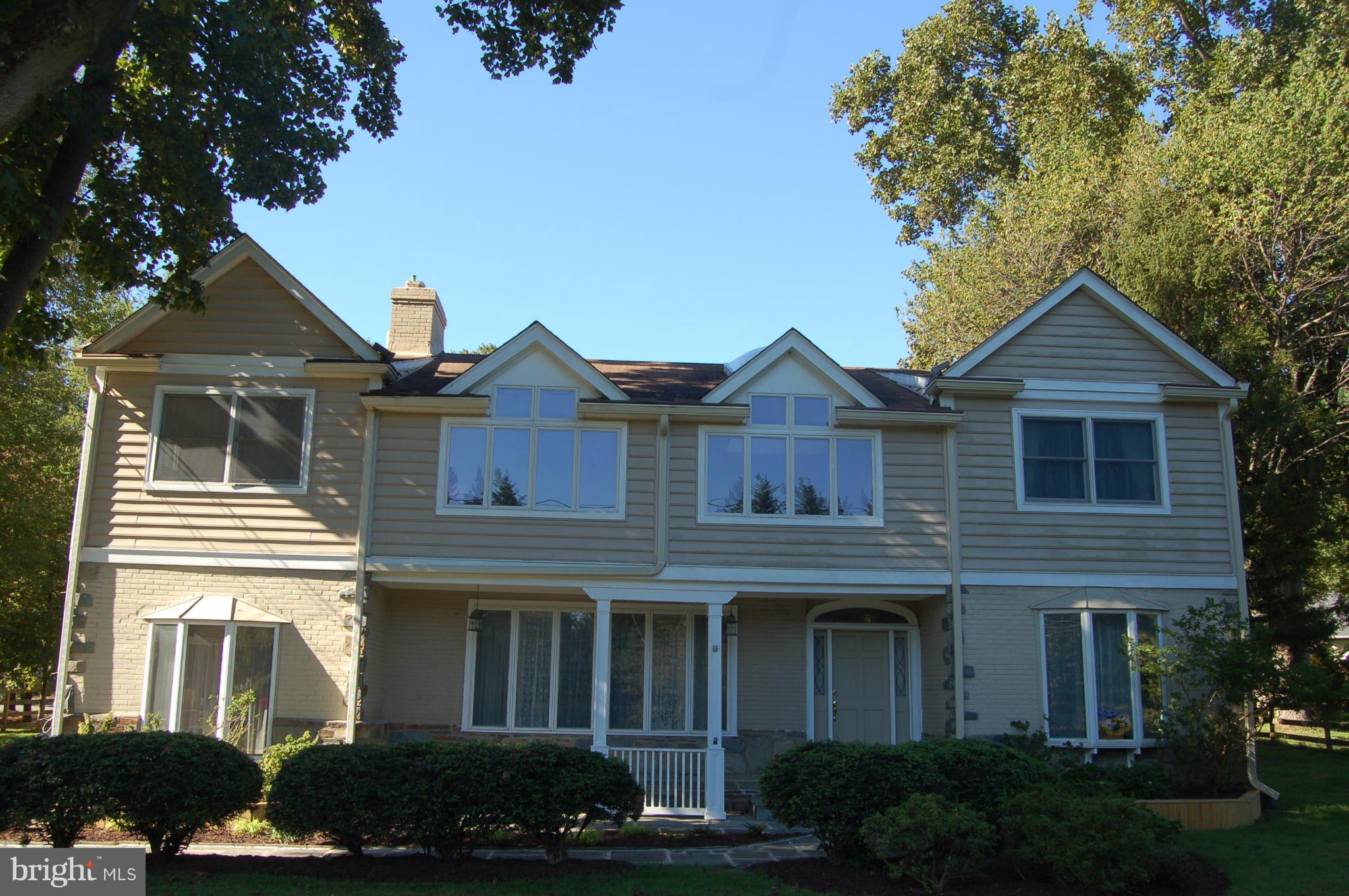 8712 Brickyard Road Potomac, MD 20854 - Photo 1 of 30 a front view of a house with a yard