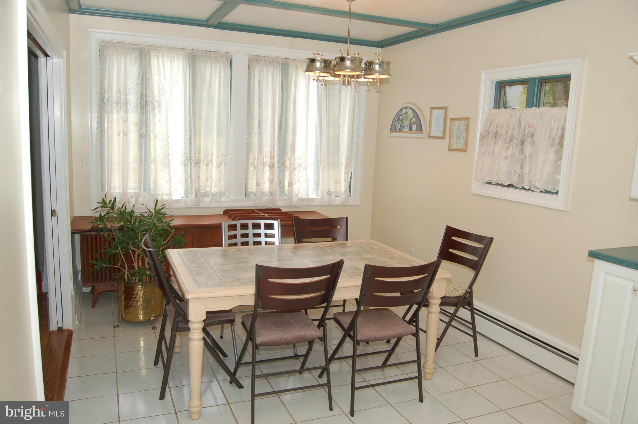 8712 Brickyard Road Potomac, MD 20854 - Photo 12 of 30 a view of a dining room with furniture and window