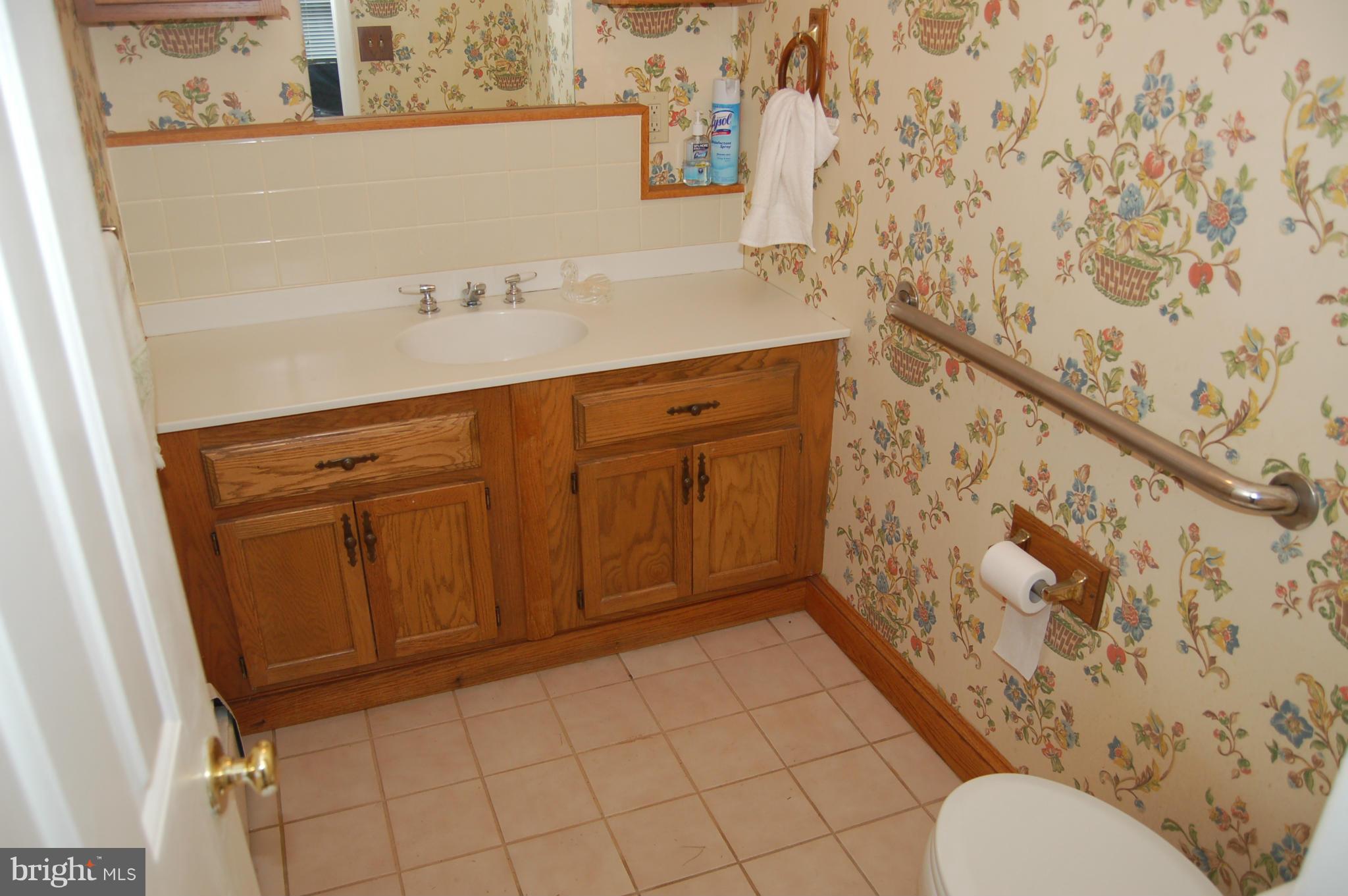 8712 Brickyard Road Potomac, MD 20854 - Photo 14 of 30 a bathroom with a toilet and a shower curtain
