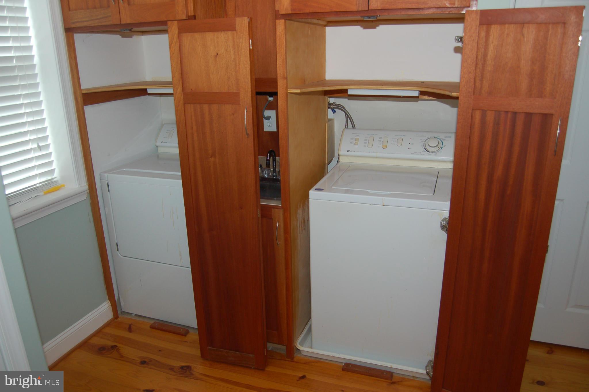 8712 Brickyard Road Potomac, MD 20854 - Photo 17 of 30 a view of a storage & utility room with a refrigerator