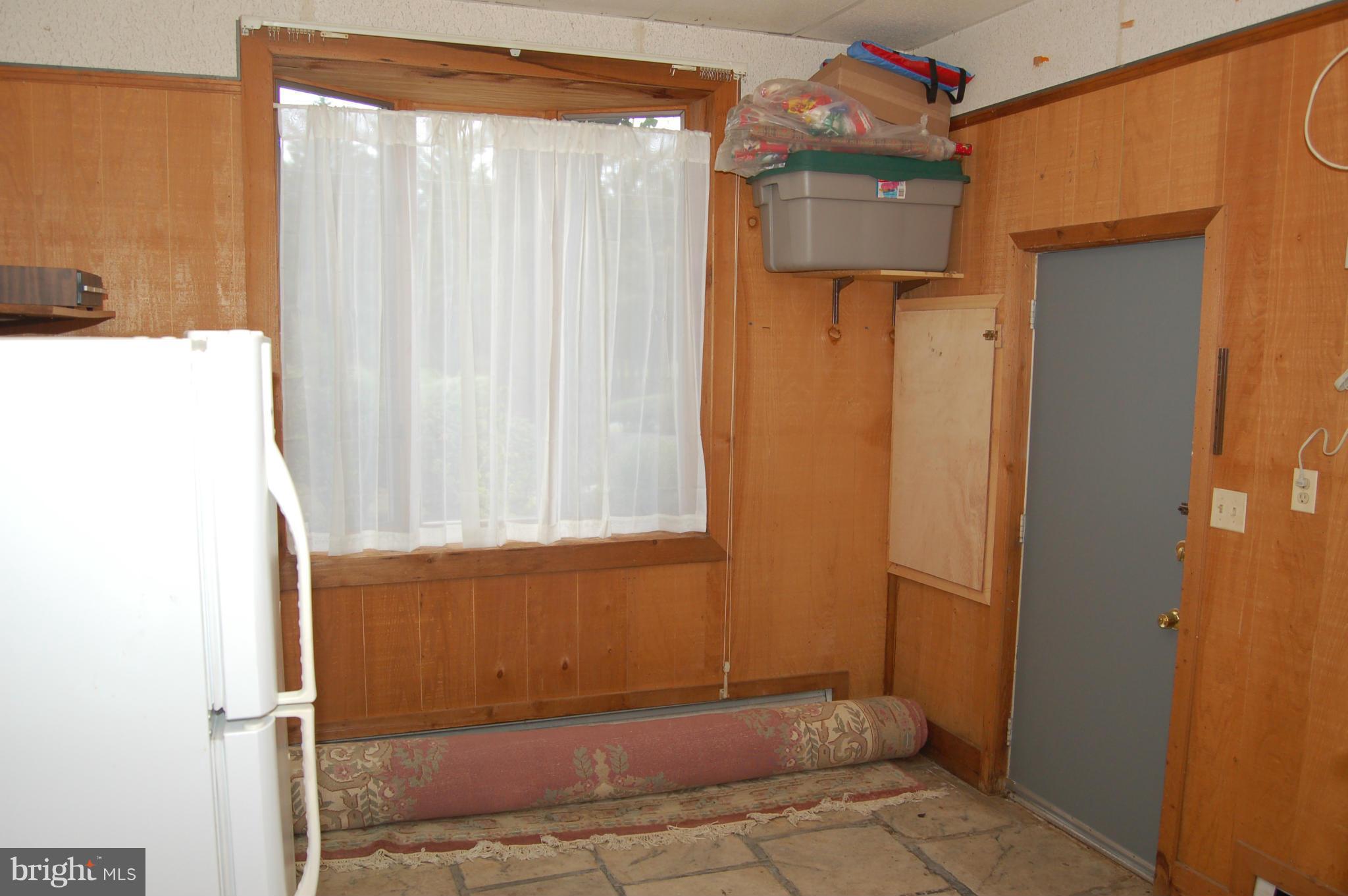 8712 Brickyard Road Potomac, MD 20854 - Photo 18 of 30 a view of a small space with wooden door and a window