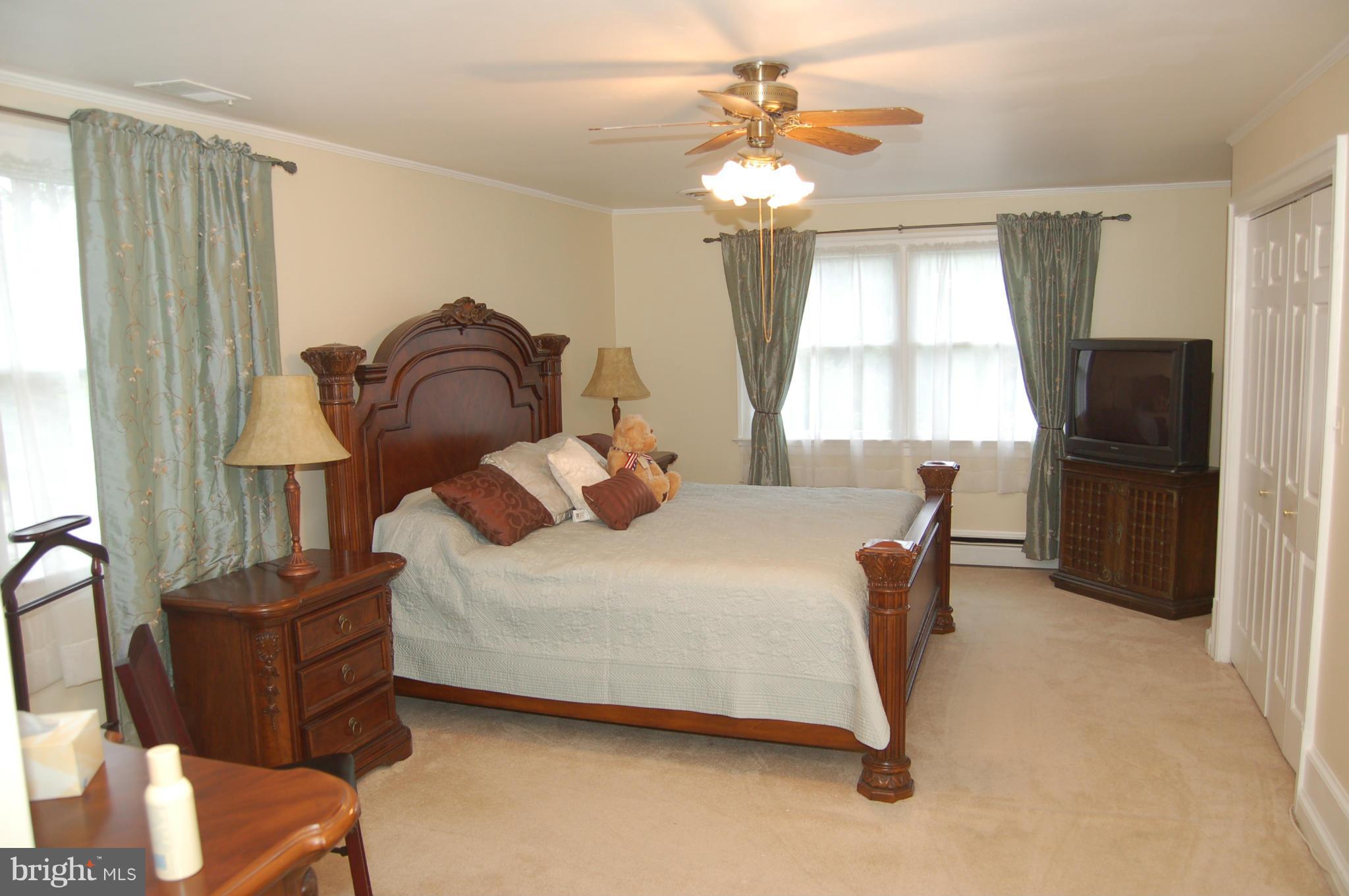 8712 Brickyard Road Potomac, MD 20854 - Photo 21 of 30 a bedroom with furniture and a window