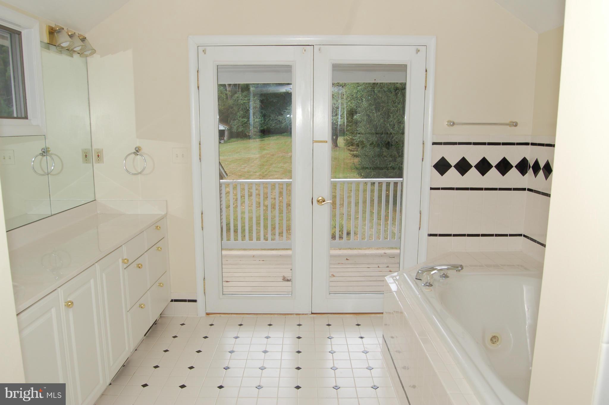 8712 Brickyard Road Potomac, MD 20854 - Photo 23 of 30 a bathroom with a sink a toilet and shower
