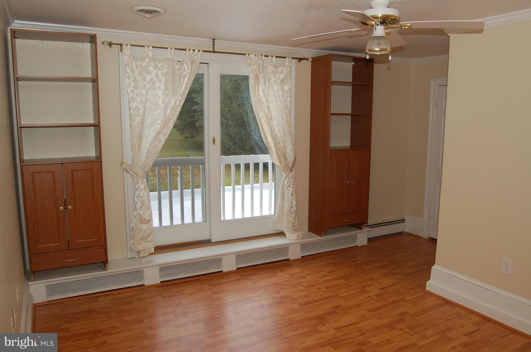 8712 Brickyard Road Potomac, MD 20854 - Photo 24 of 30 wooden floor in an empty room with a window