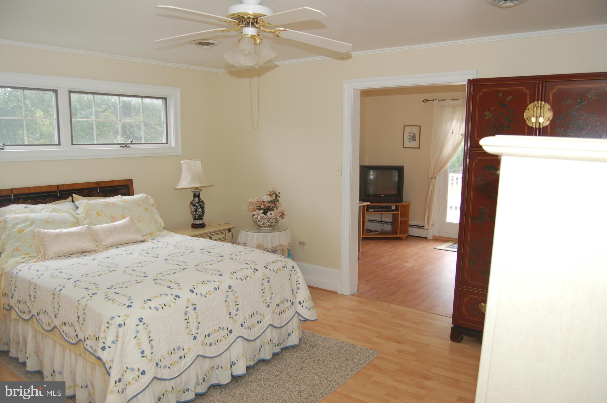 8712 Brickyard Road Potomac, MD 20854 - Photo 25 of 30 a bedroom with a bed and a chandelier
