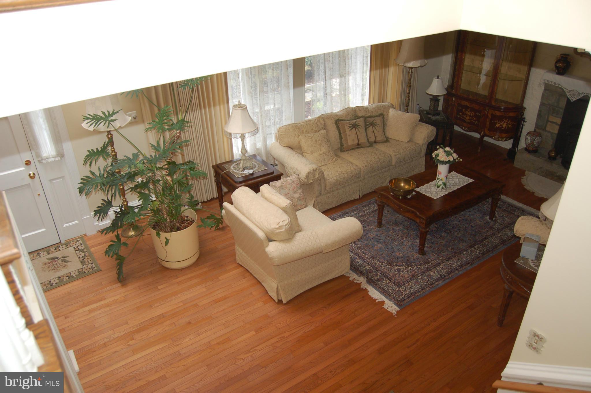 8712 Brickyard Road Potomac, MD 20854 - Photo 8 of 30 a living room with furniture and wooden floor