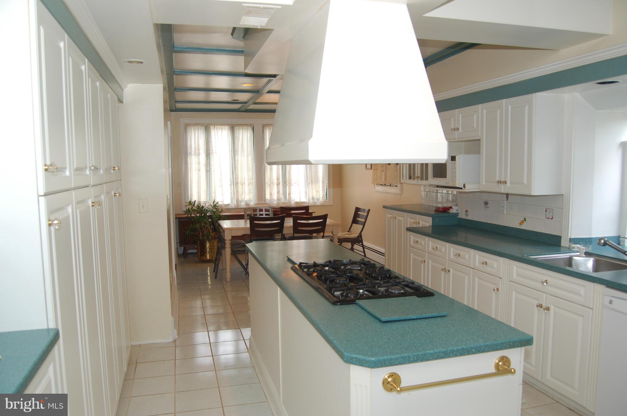 8712 Brickyard Road Potomac, MD 20854 - Photo 10 of 30 a kitchen with a stove a sink and a refrigerator