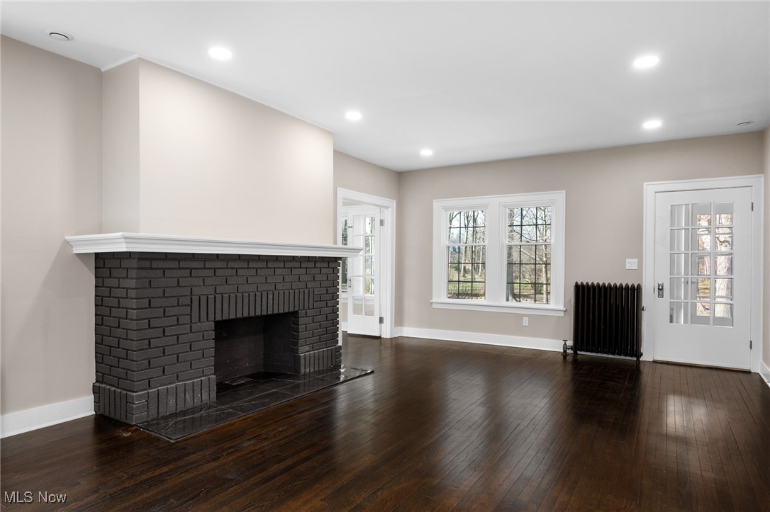 2854 Corydon Road Cleveland, OH 44118 - Photo 5 of 41 Unfurnished living room featuring radiator heating unit, hardwood / wood-style flooring, a fireplace, and recessed lighting