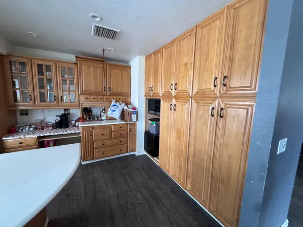 a kitchen with stainless steel appliances a refrigerator sink and cabinets