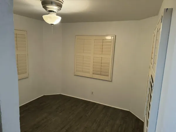 en empty room with wooden floor and window