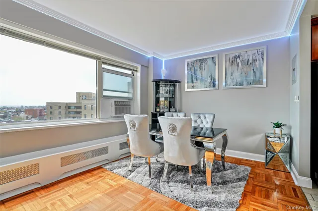 a dining room with furniture a rug and wooden floor