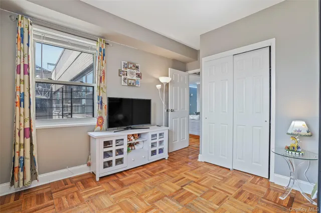 a bedroom with furniture and flat screen tv