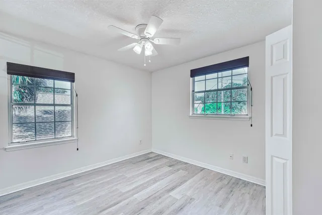 a bedroom with a large bed and a potted plant