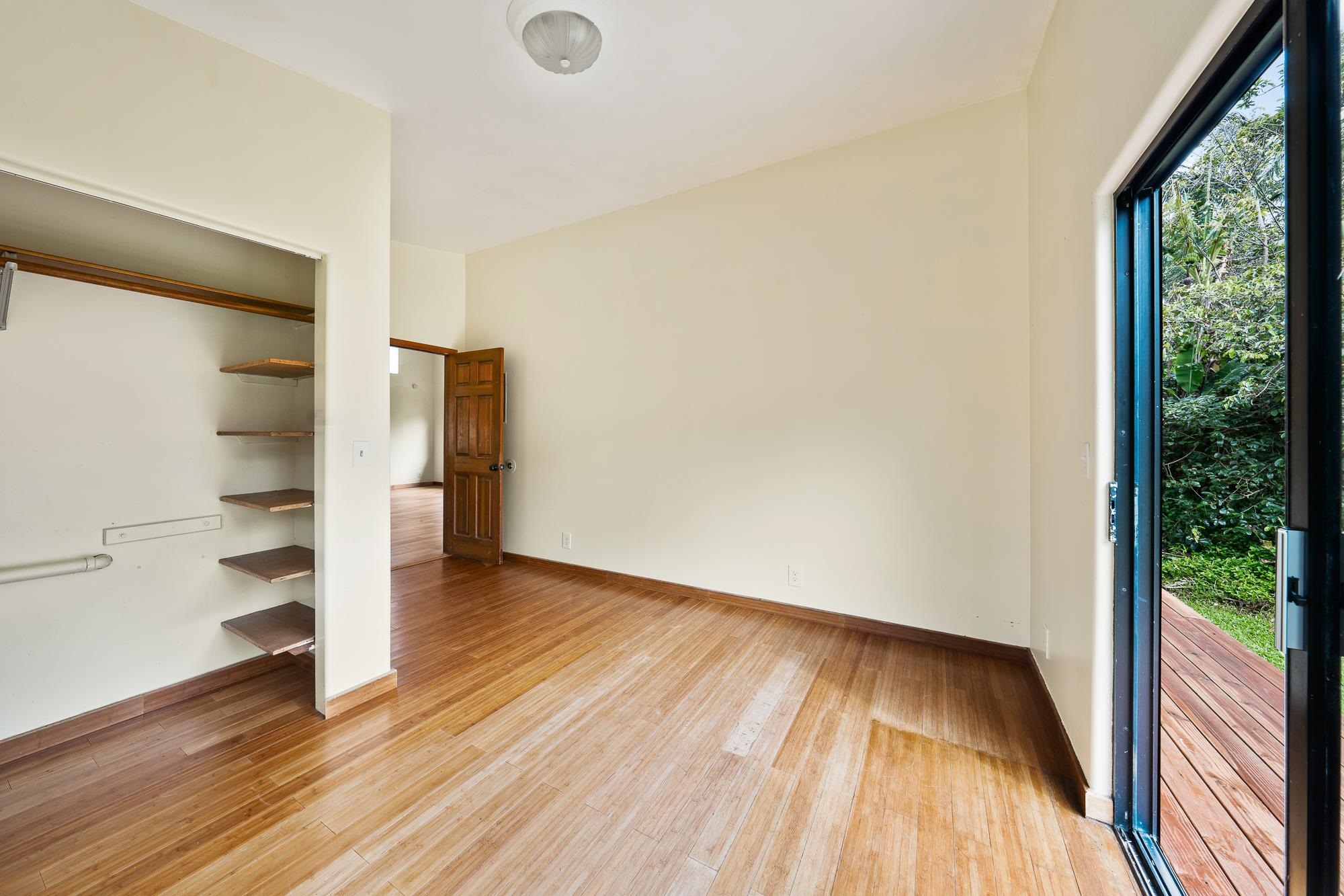 323 Door Of Faith Road Haiku, HI 96708 - Photo 13 of 48 wooden floor in an empty room with a window