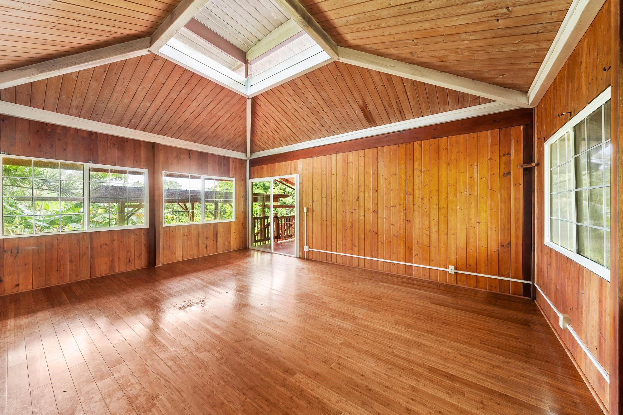 323 Door Of Faith Road Haiku, HI 96708 - Photo 42 of 48 a view of a room with wooden floor and iron stairs