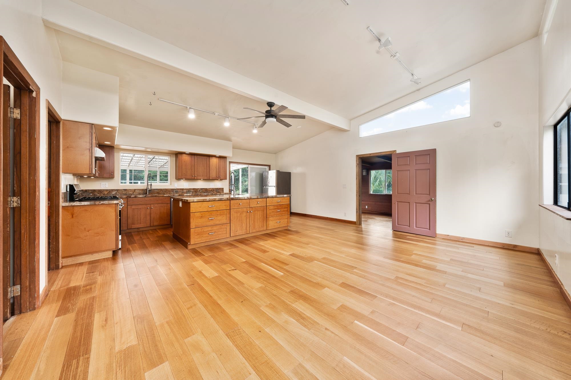 323 Door Of Faith Road Haiku, HI 96708 - Photo 7 of 48 a large kitchen with stainless steel appliances kitchen island a large counter top and a wooden floors