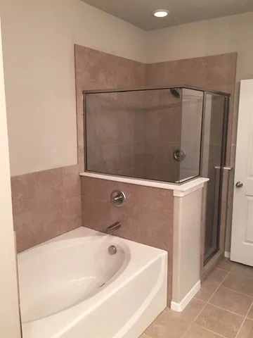 a bathroom with a tub and a shower