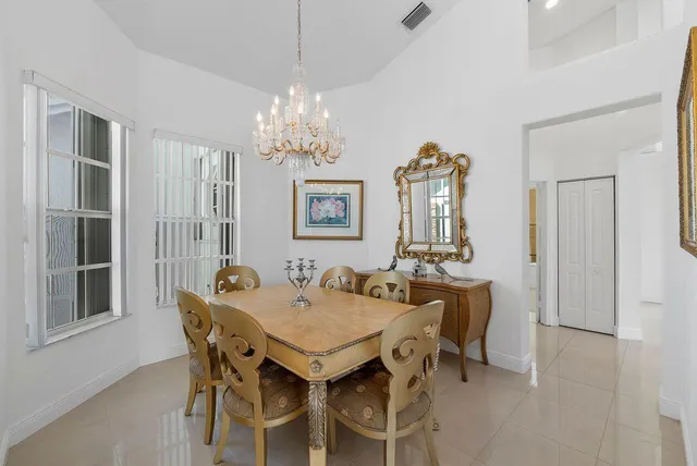 a view of a dining room with furniture a chandelier and wooden floor