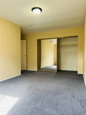 an empty room with closet area