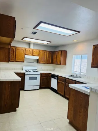 a kitchen with stainless steel appliances a stove a sink and a microwave