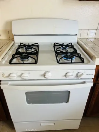 a close view of a stove top oven sitting on a white counter top