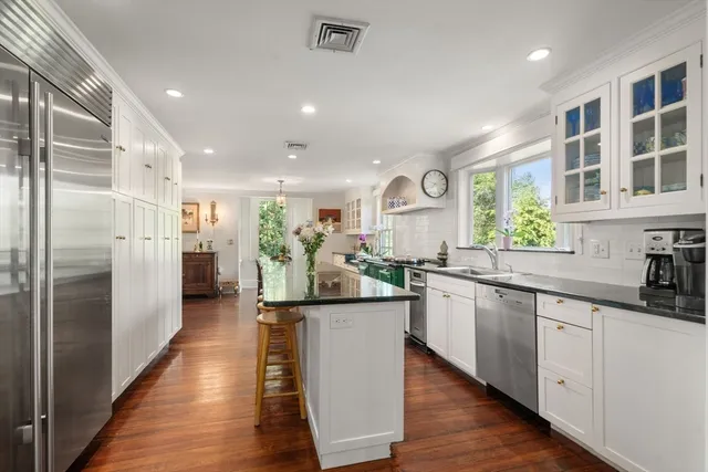 a kitchen with stainless steel appliances granite countertop refrigerator sink and cabinets