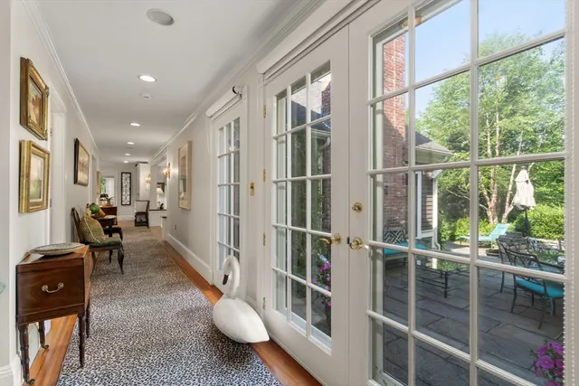 a living room with furniture a flat screen tv and a floor to ceiling window