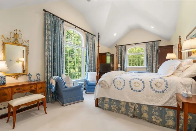 a bedroom with a bed and a large window