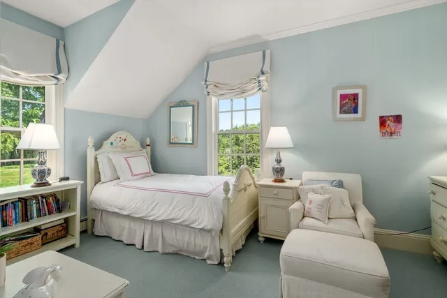 a bedroom with a bed furniture and a window