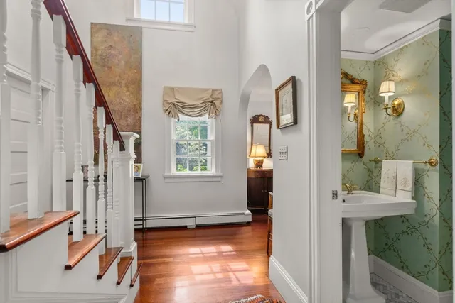 a view of an entryway with wooden floor and a bathroom