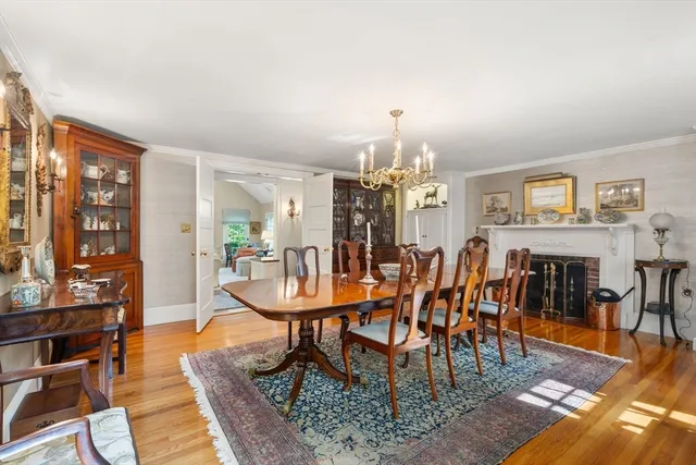 a view of a a dining room with furniture window and wooden floor