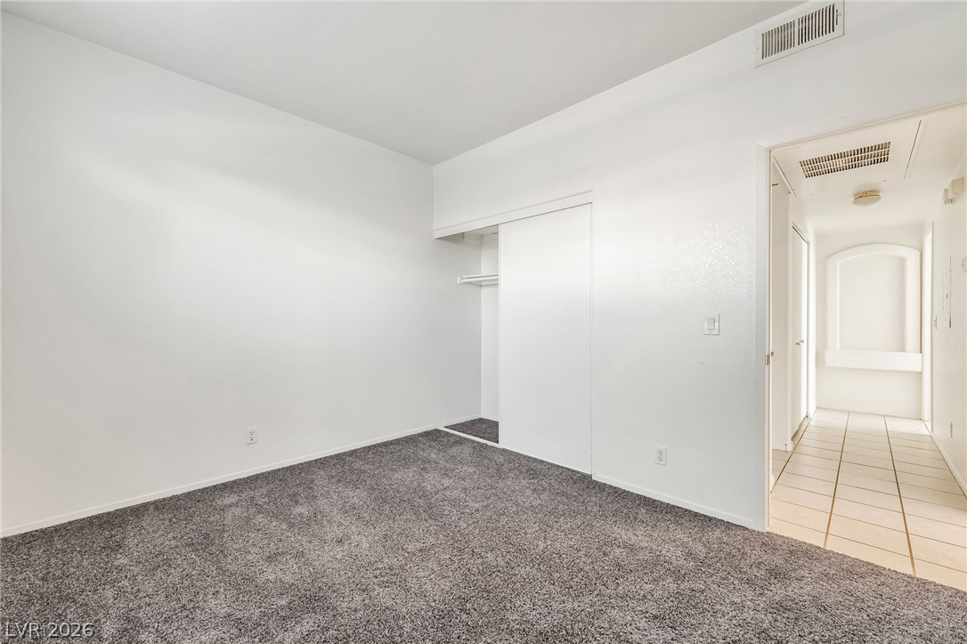 2201 Ramsgate Drive, Unit 811 Henderson, NV 89074 - Photo 23 of 36 A spacious bedroom offers a neutral canvas, ready for personalized touches.