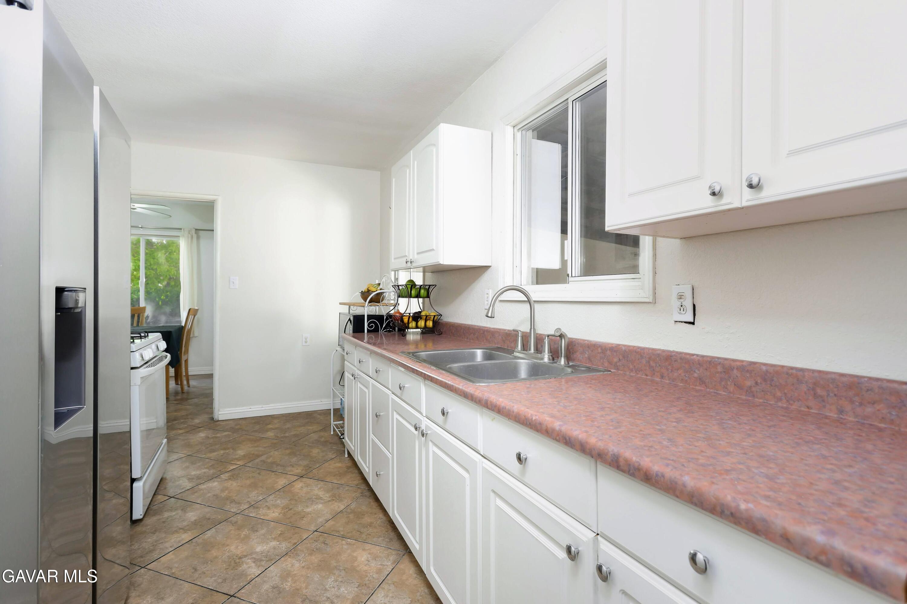 44265 Foxton Avenue Lancaster, CA 93535 - Photo 11 of 20 a kitchen with granite countertop a sink and cabinets